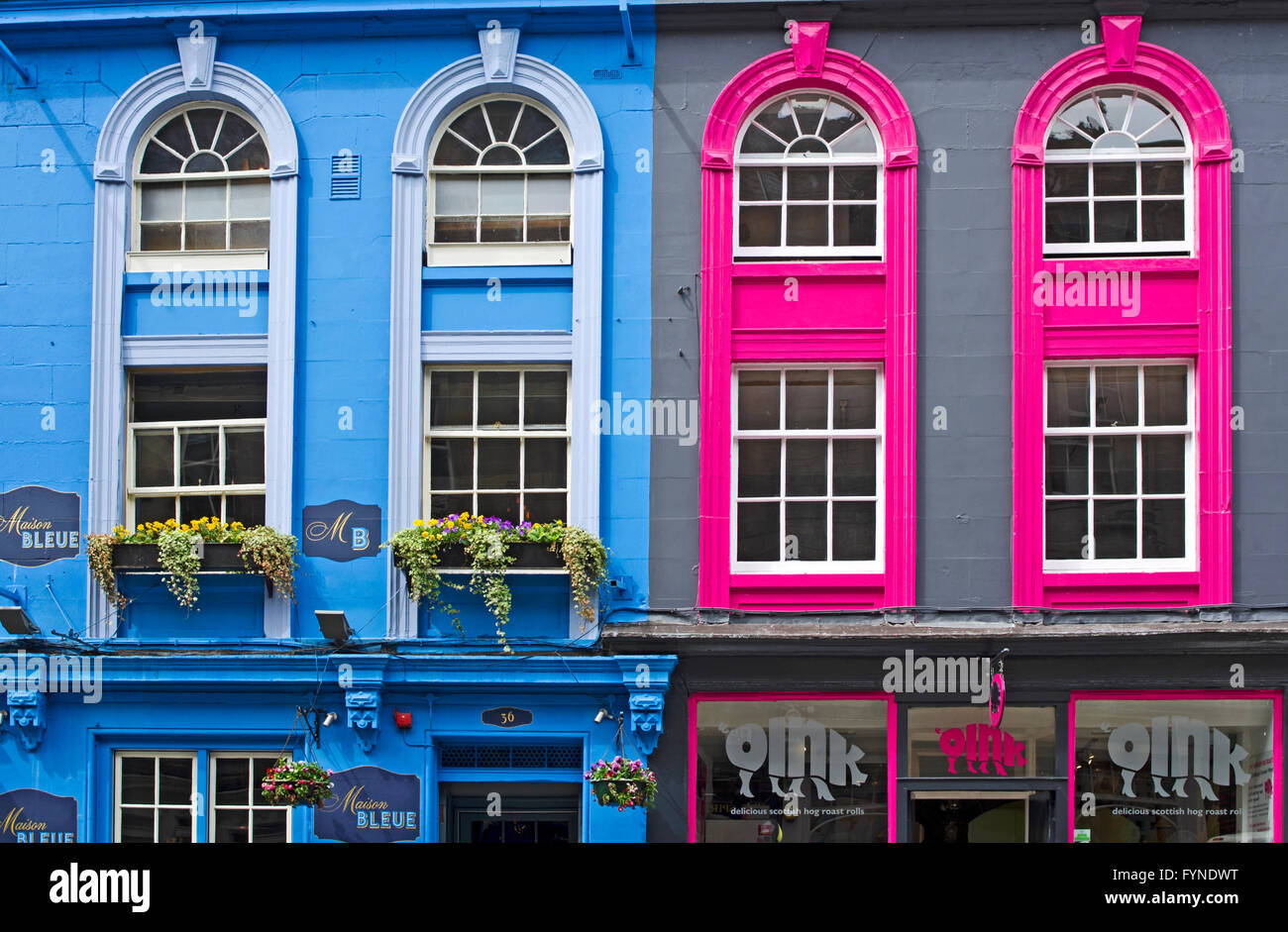 Close-up of brightly painted facades of two store fronts on Victoria Street, Edinburgh Old Town, Scotland UK Stock Photo