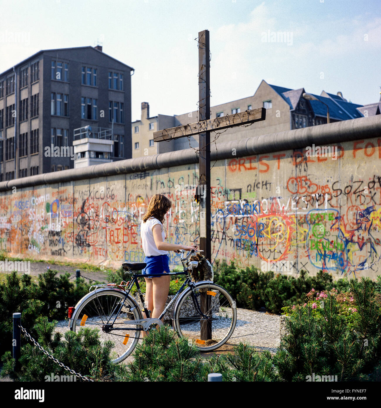 August 1986, young woman with bike, Peter Fechter memorial, graffitis on Berlin Wall, Zimmerstrasse street, Kreuzberg, West Berlin, Germany, Europe, Stock Photo