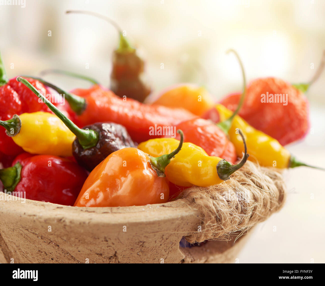 hot pepper mix photographed in a stone basket Stock Photo Alamy