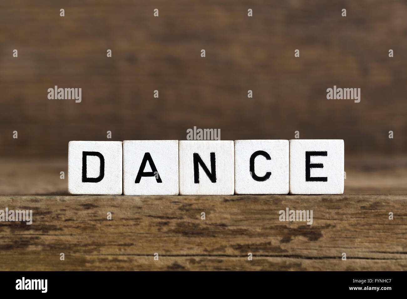 The word dance written in cubes on wooden background Stock Photo