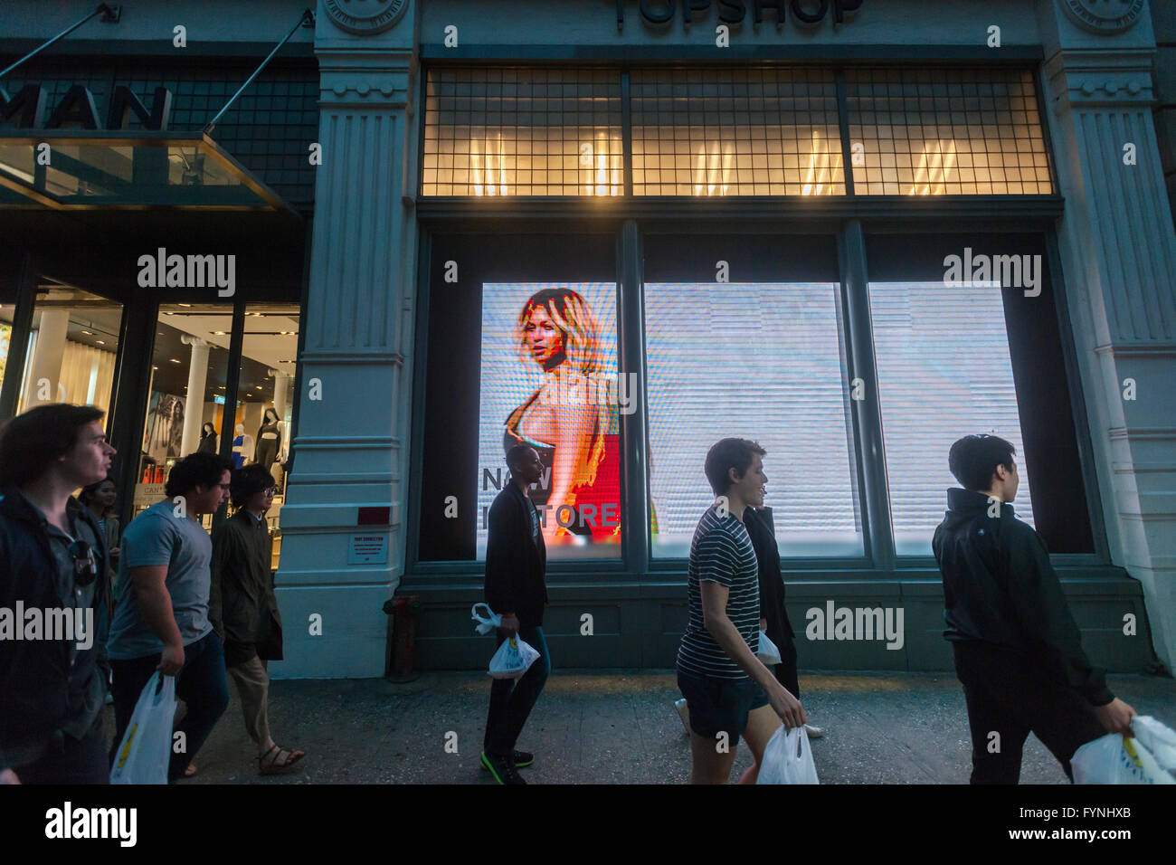 The Topshop Topman store in Soho in New York promotes Ivy Park, Beyoncé's line of athleisure wear, with a large window display containing an illuminated billboard showing a promotional video, seen on Tuesday, April 26, 2016. Residents of Soho and the Business Improvement District are complaining that the illuminated sign is not appropriate for the neighborhood. (© Richard B. Levine) Stock Photo
