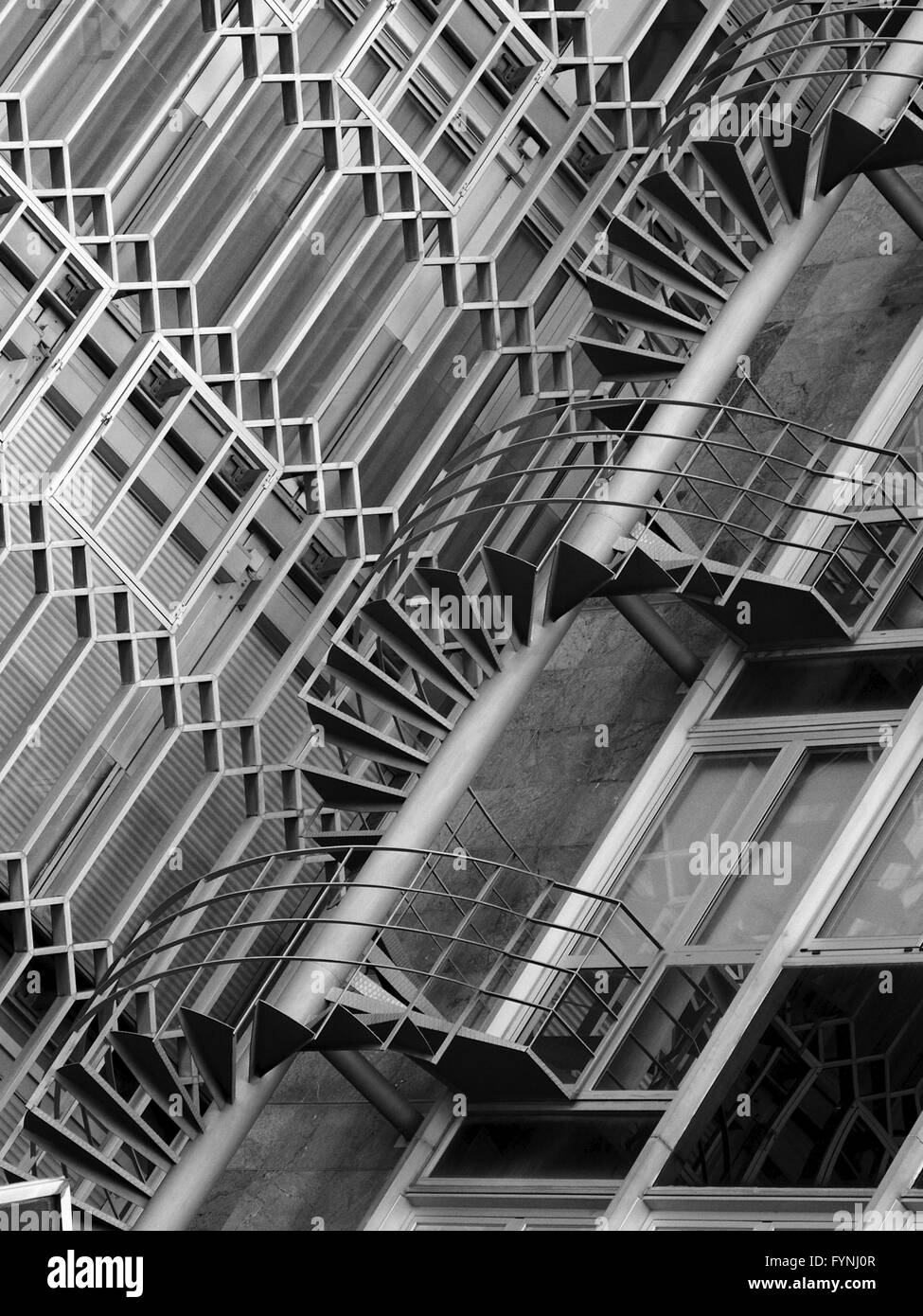 Mono image of external winding stairs and exterior architectural details on office building in Barcelona, Spain Stock Photo