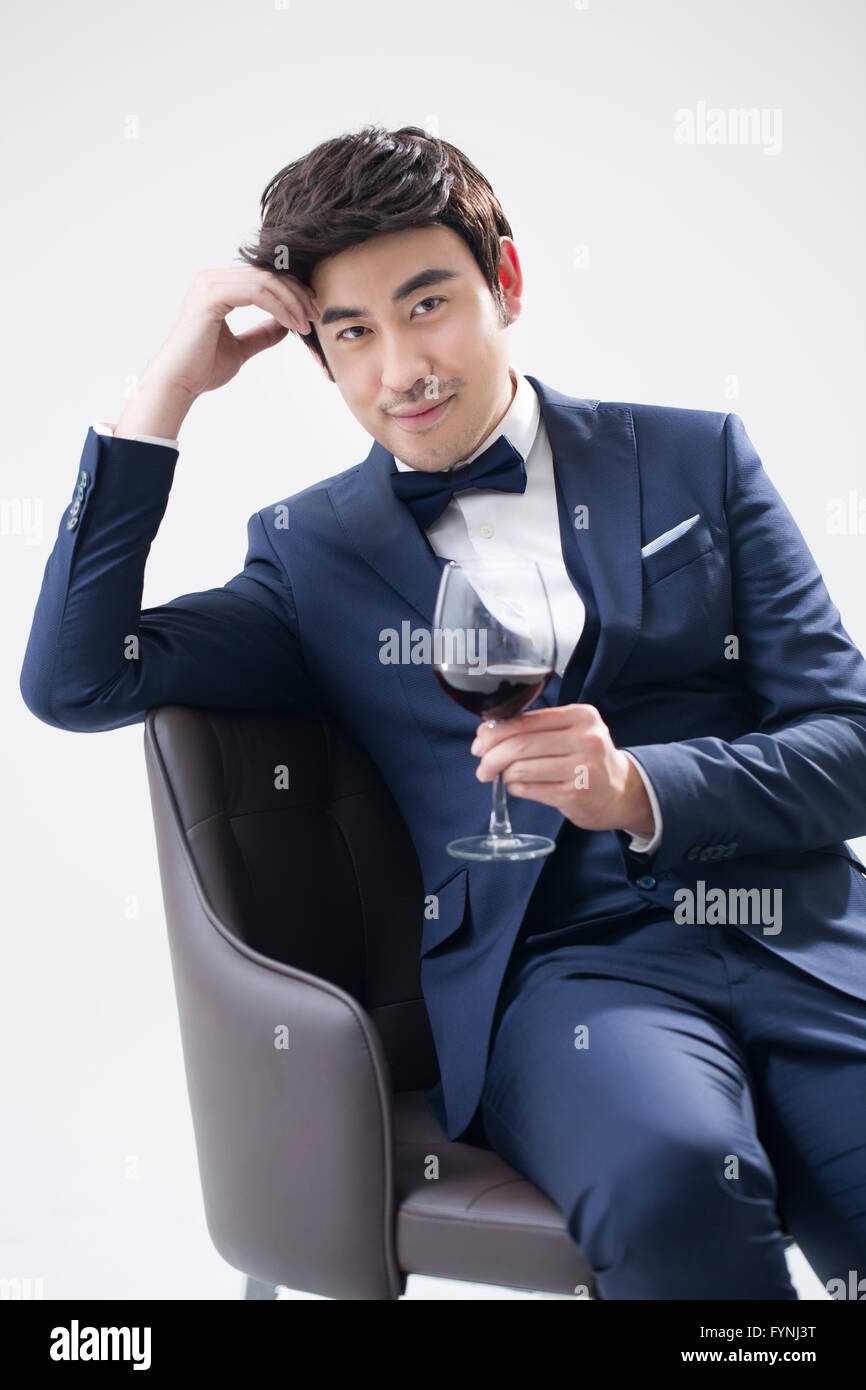 Elegant young man enjoying red wine Stock Photo Alamy