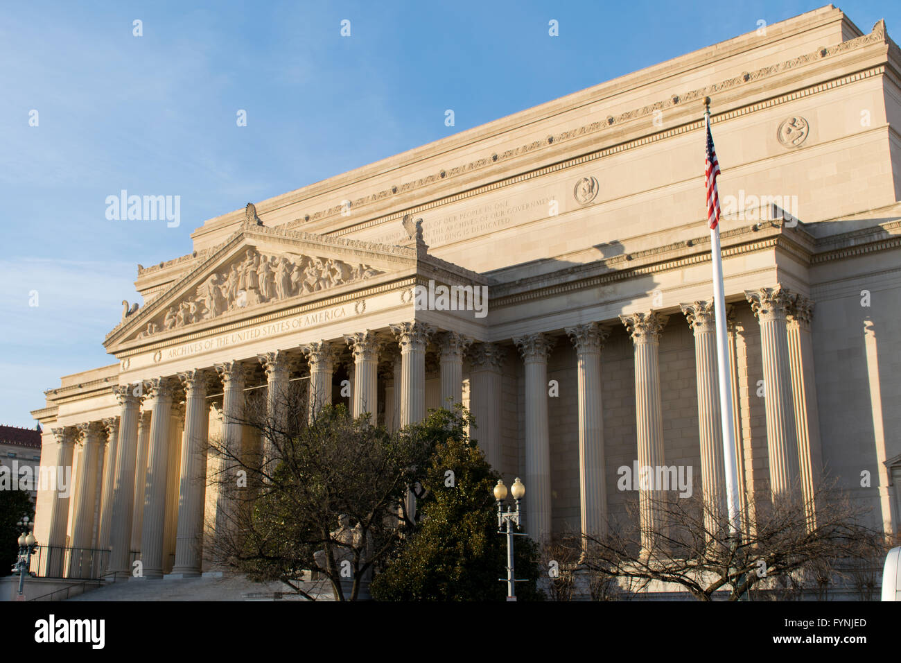 WASHINGTON, DC, United States — The National Archives Building stands prominently on Constitution Avenue in Washington, DC. The neoclassical structure, opened in 1935, features a grand façade with Corinthian columns and sculptures. This Constitution Avenue side of the building houses the Rotunda for the Charters of Freedom, where the United States Constitution, Declaration of Independence, and Bill of Rights are displayed. Stock Photo