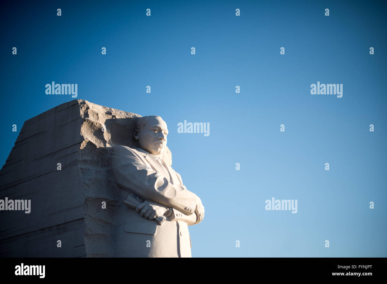 WASHINGTON, DC - The main statue of Dr. Martin Luther King Jr. at the MLK Memorial on the banks of the Tidal Basin in Washington DC. The main statue, by Chinese sculptor Lei Yixin, stands here against a clear blue sky with copyspace. Stock Photo