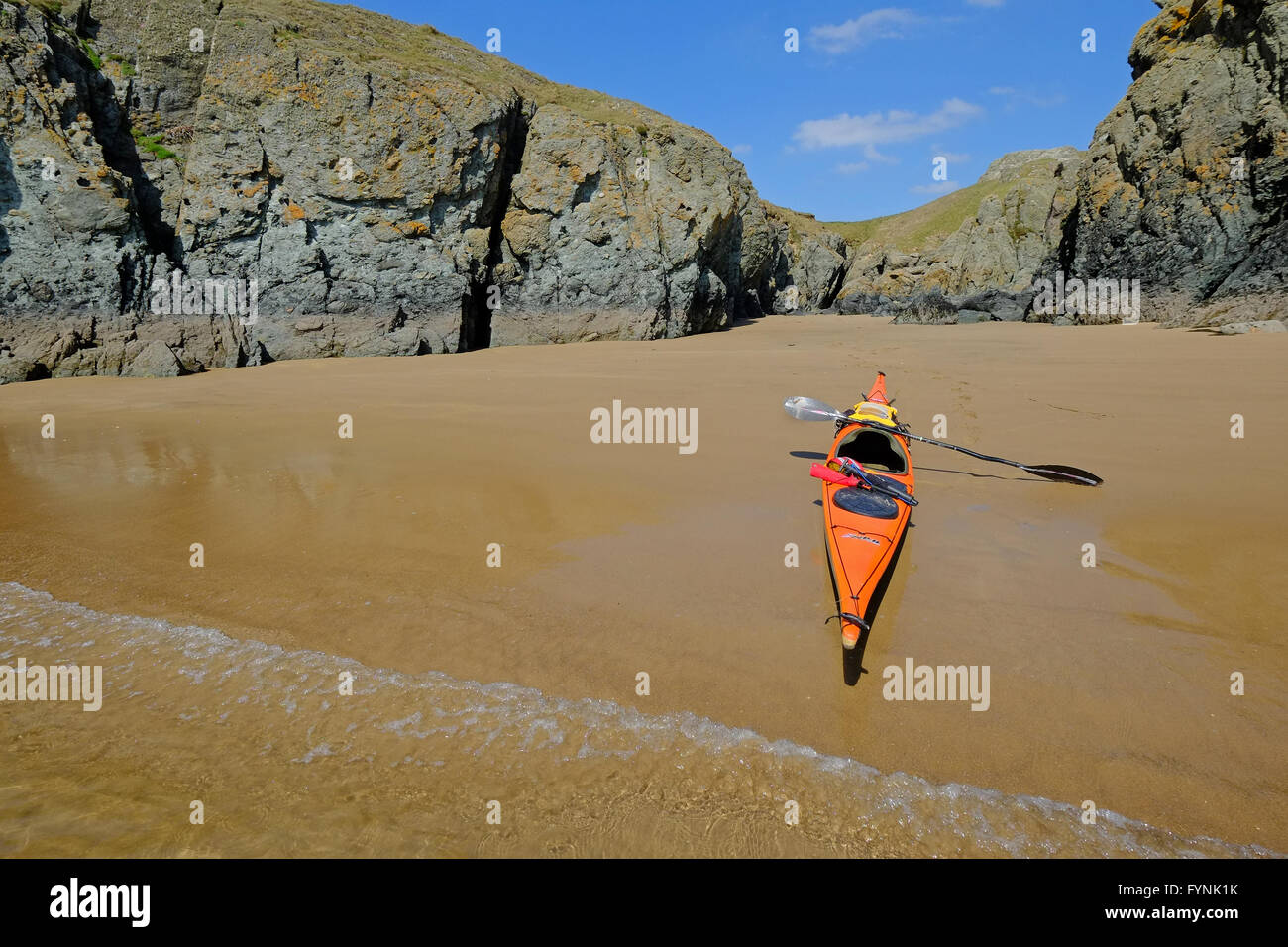 A sea kayak on a sandy beach near Malltraeth on the west coast of Anglesey, North Wales Stock Photo