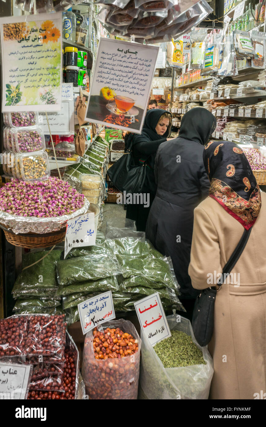 Iranian women in hijabs shopping in a spice and herb shop in Tehran, Iran. Stock Photo
