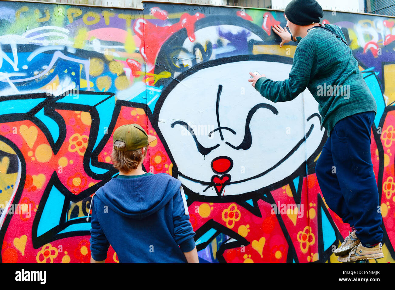 Male teen painting wall spray paint hi-res stock photography and images ...