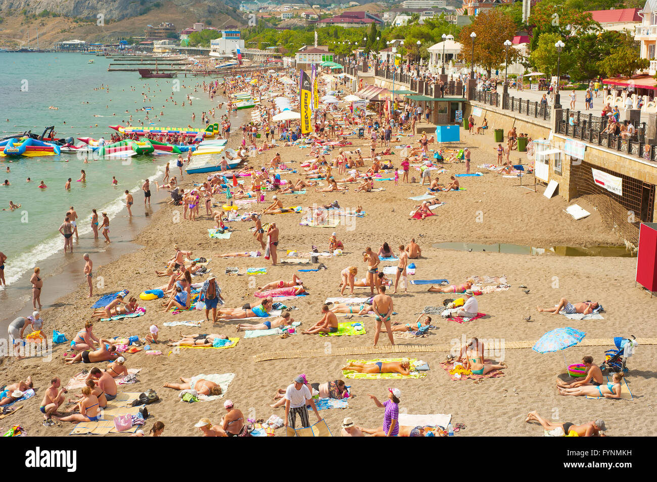 People at a sea beach in Sudak. Crimea Stock Photo
