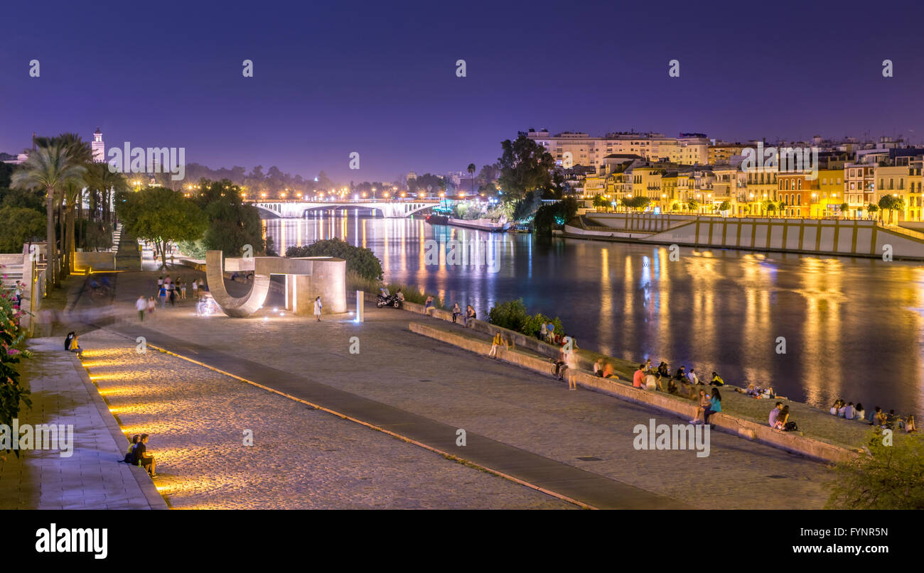 Seville is divided in two by the river Guadalquivir. On the west side is located the Triana neighborhood known by its traditional flamenco. Stock Photo