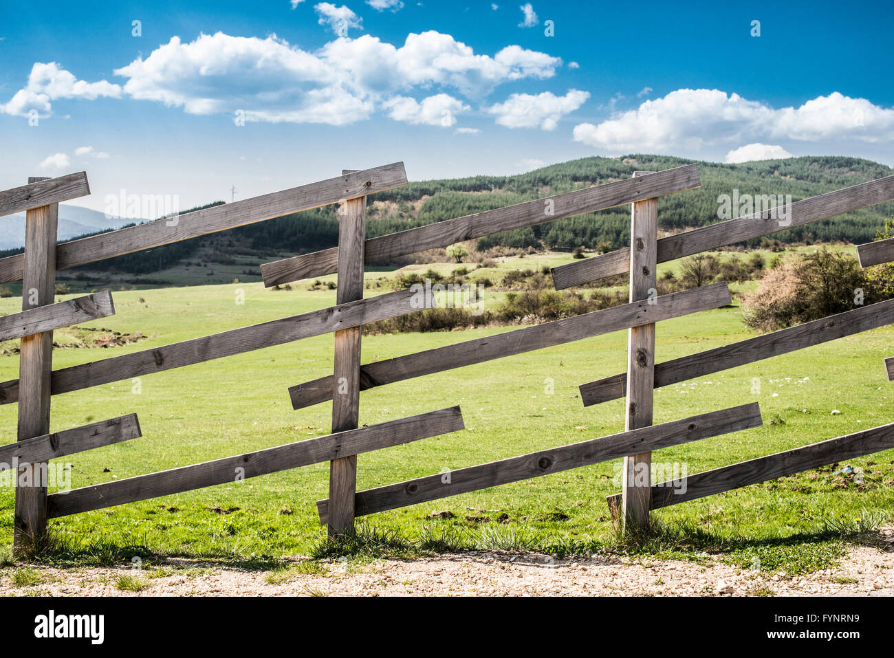 Wooden fence on a mountain ranch. Sunlight Stock Photo