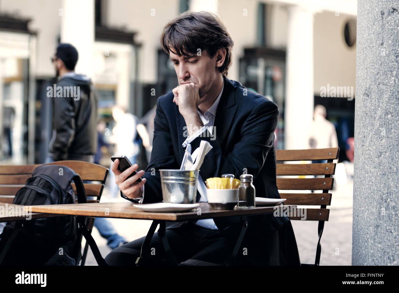 Businessman checking his phone Stock Photo - Alamy
