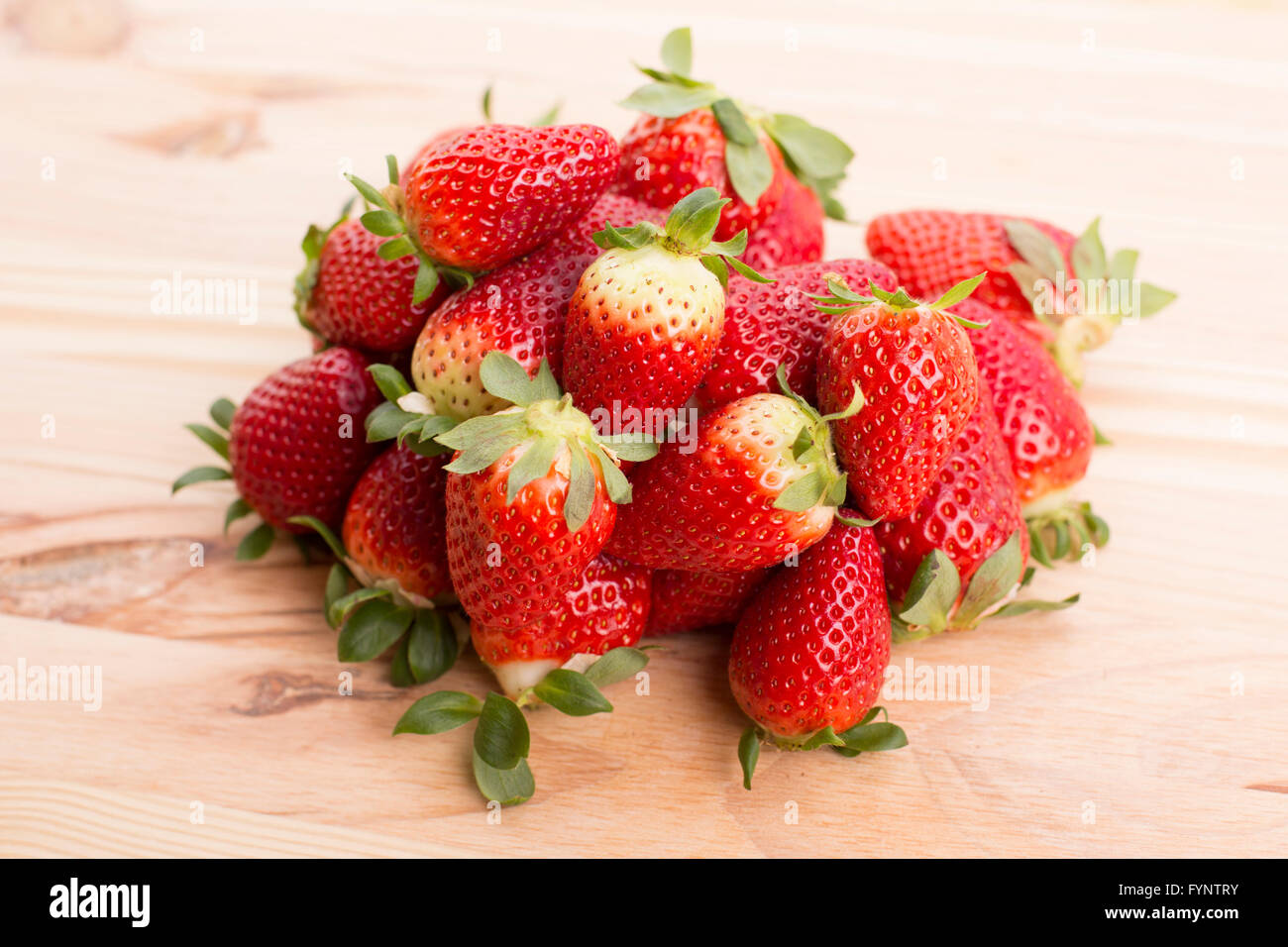 strawberries on a wooden table, studio picture Stock Photo - Alamy