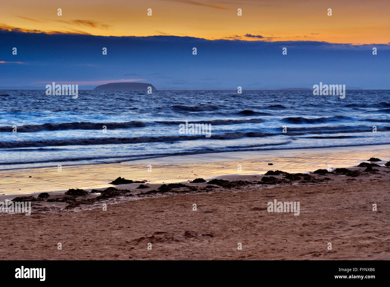 Sunset at Berrow Beach, Burnham-On-Sea, Somerset, UK with Steepholm Island on the horizon Stock Photo
