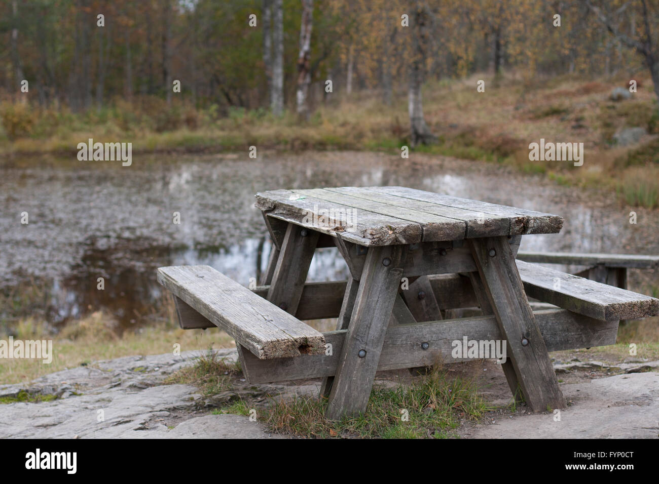 Old wooden picnic table by lake Stock Photo - Alamy