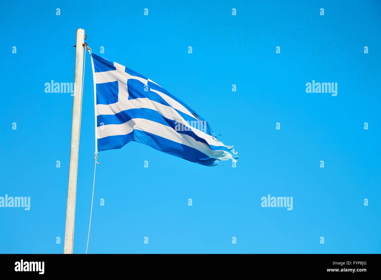 waving flag in blue sky and flagpole Stock Photo - Alamy