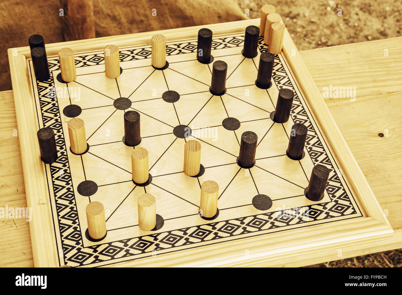 Wooden brain board game. Leisure game. Alquerque board game. Stock Photo