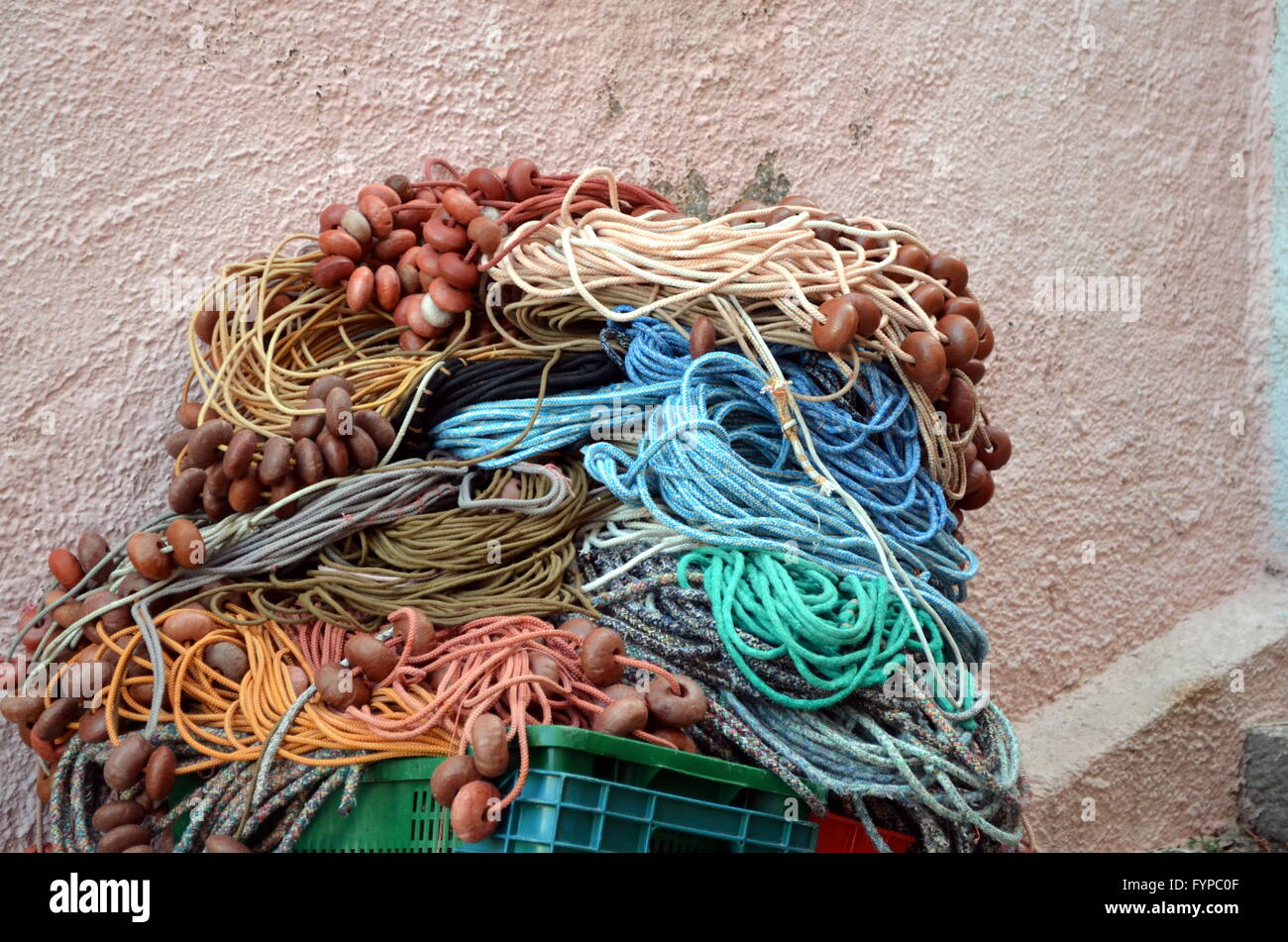 Image of fishing nets, floats, and rusty chain at seaside harbour Stock Photo