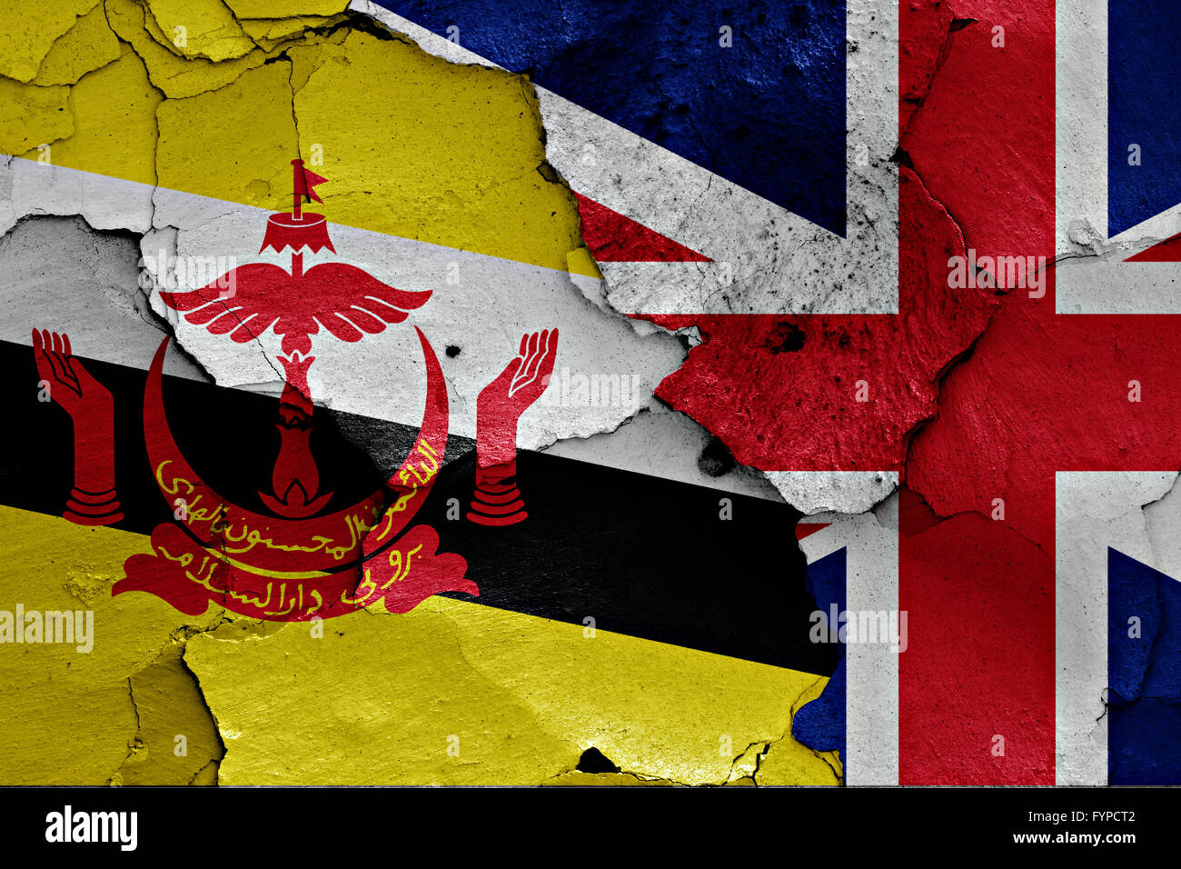 flags of Brunei and UK painted on cracked wall Stock Photo
