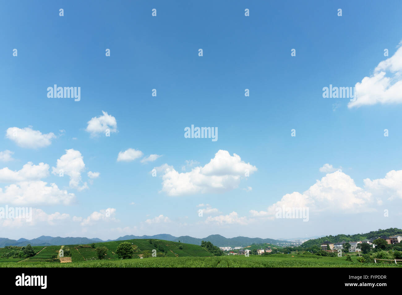 village under clear, blue sky and white clouds Stock Photo - Alamy