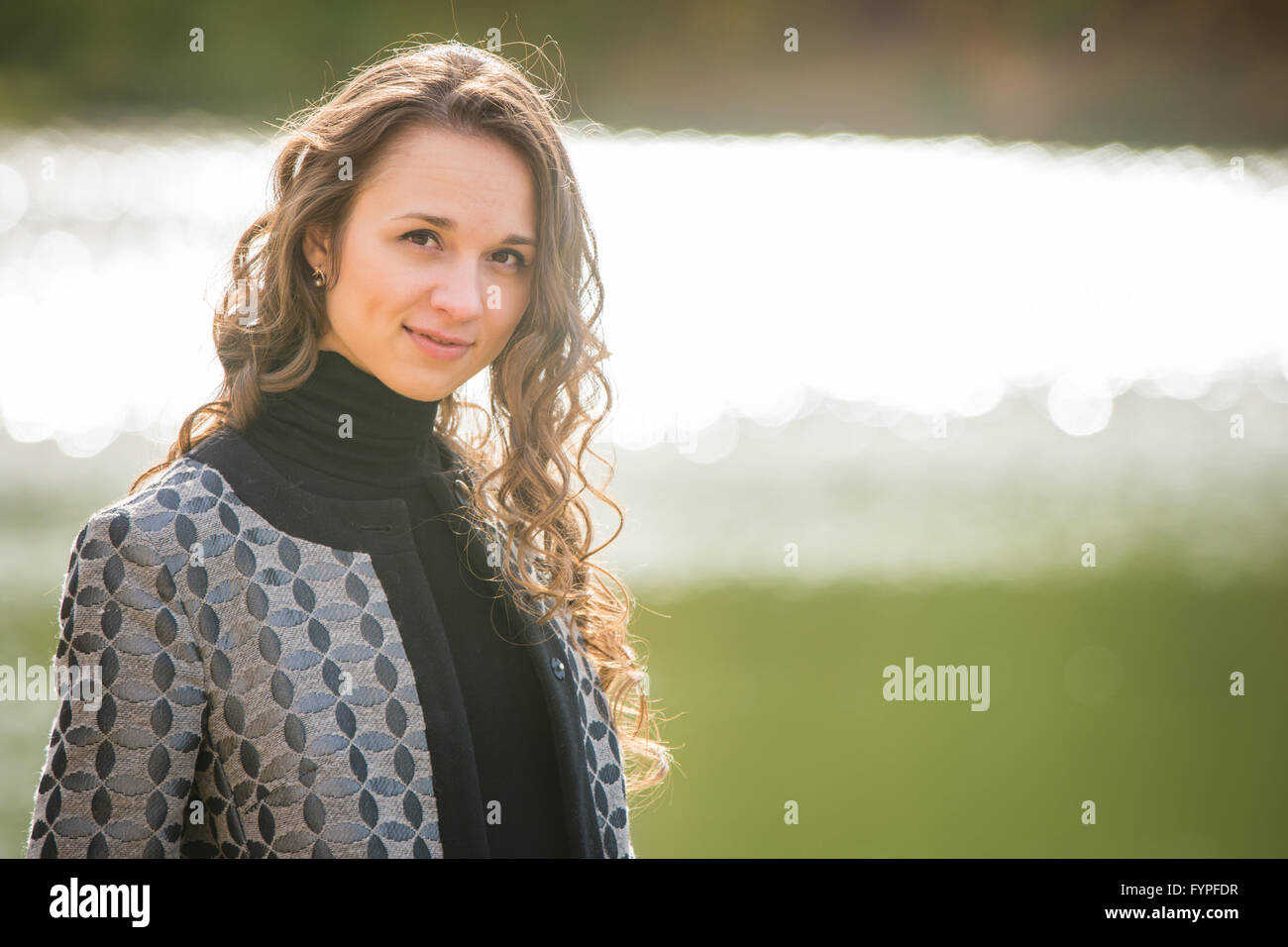 Portrait of a young girl on a background autumn coat River Stock Photo ...