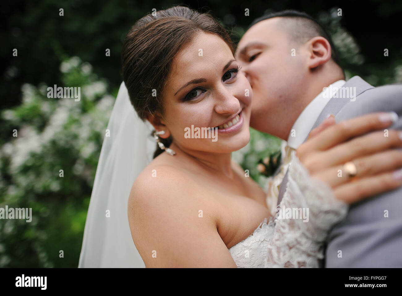 Groom kissing his bride close up Stock Photo