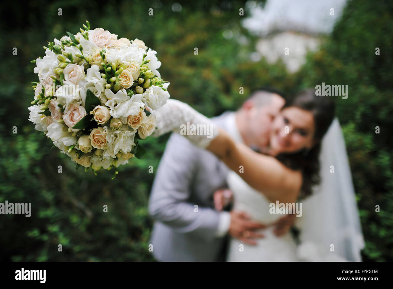 Wedding bouquet at hands of bride Stock Photo