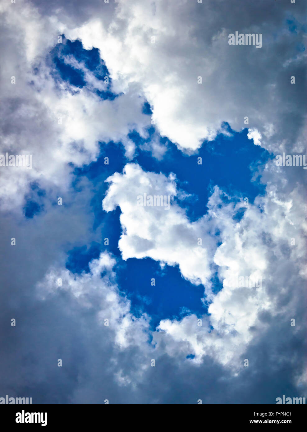 White and dark clouds on blue sky Stock Photo