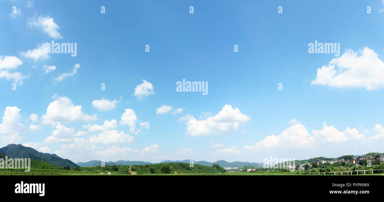 village under clear, blue sky and white clouds Stock Photo - Alamy