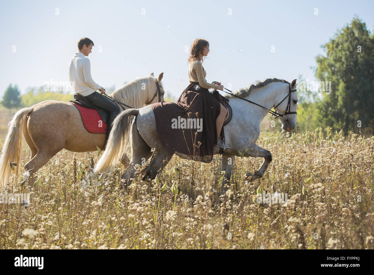 Young couple in love riding a horse Stock Photo