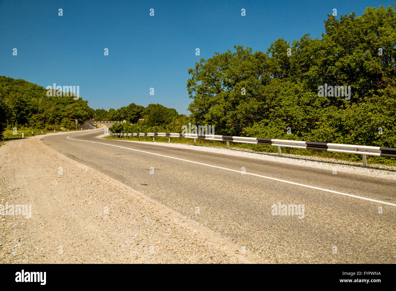 Curved asphalt road in mountains Stock Photo - Alamy