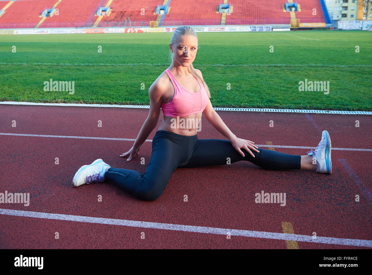 sporty woman on athletic race track Stock Photo