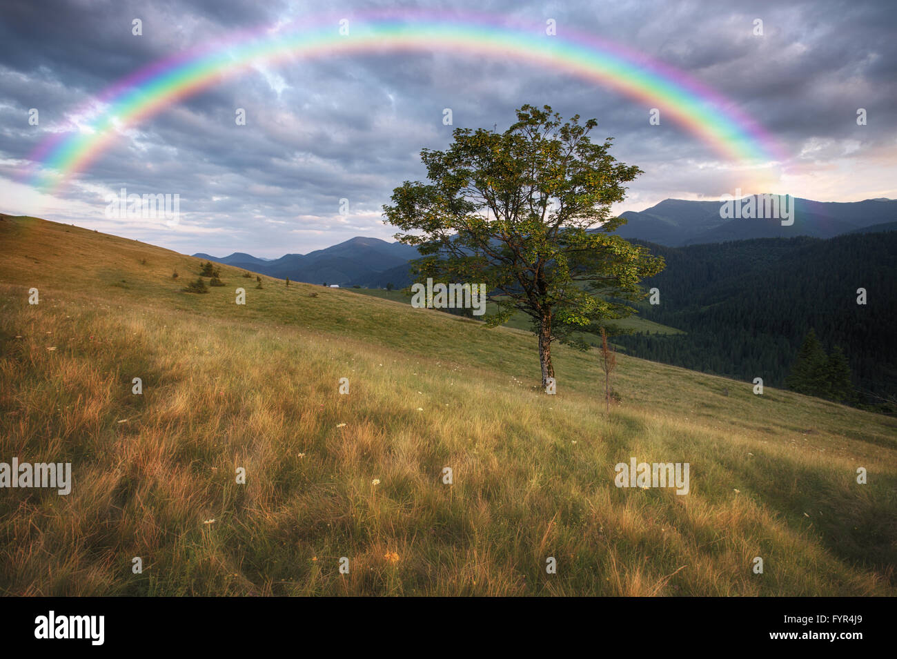 Mountains rural landscape and rainbow Stock Photo