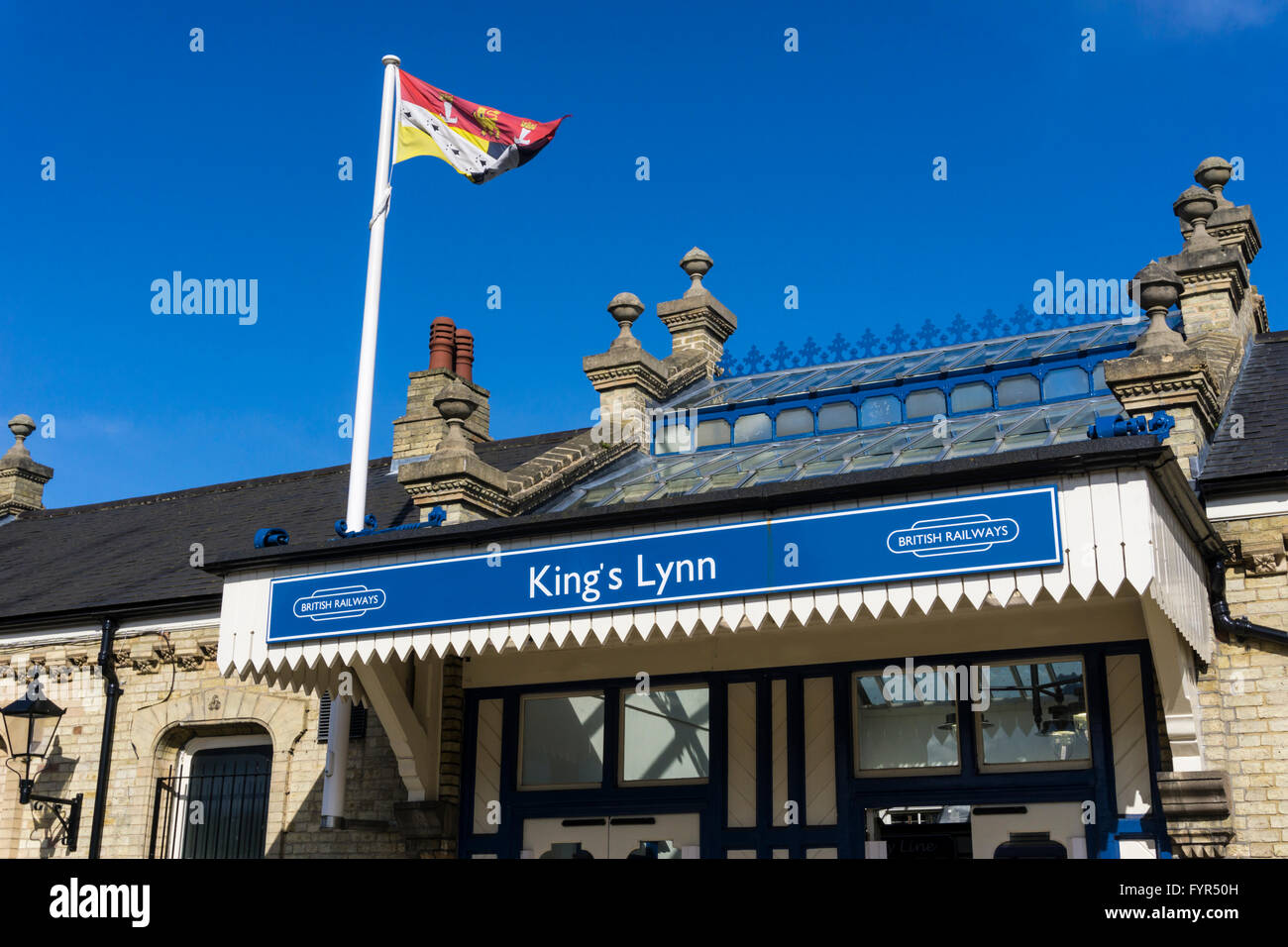 The Norfolk flag flying over refurbished King's Lynn railway station featuring British Railways branding. Stock Photo