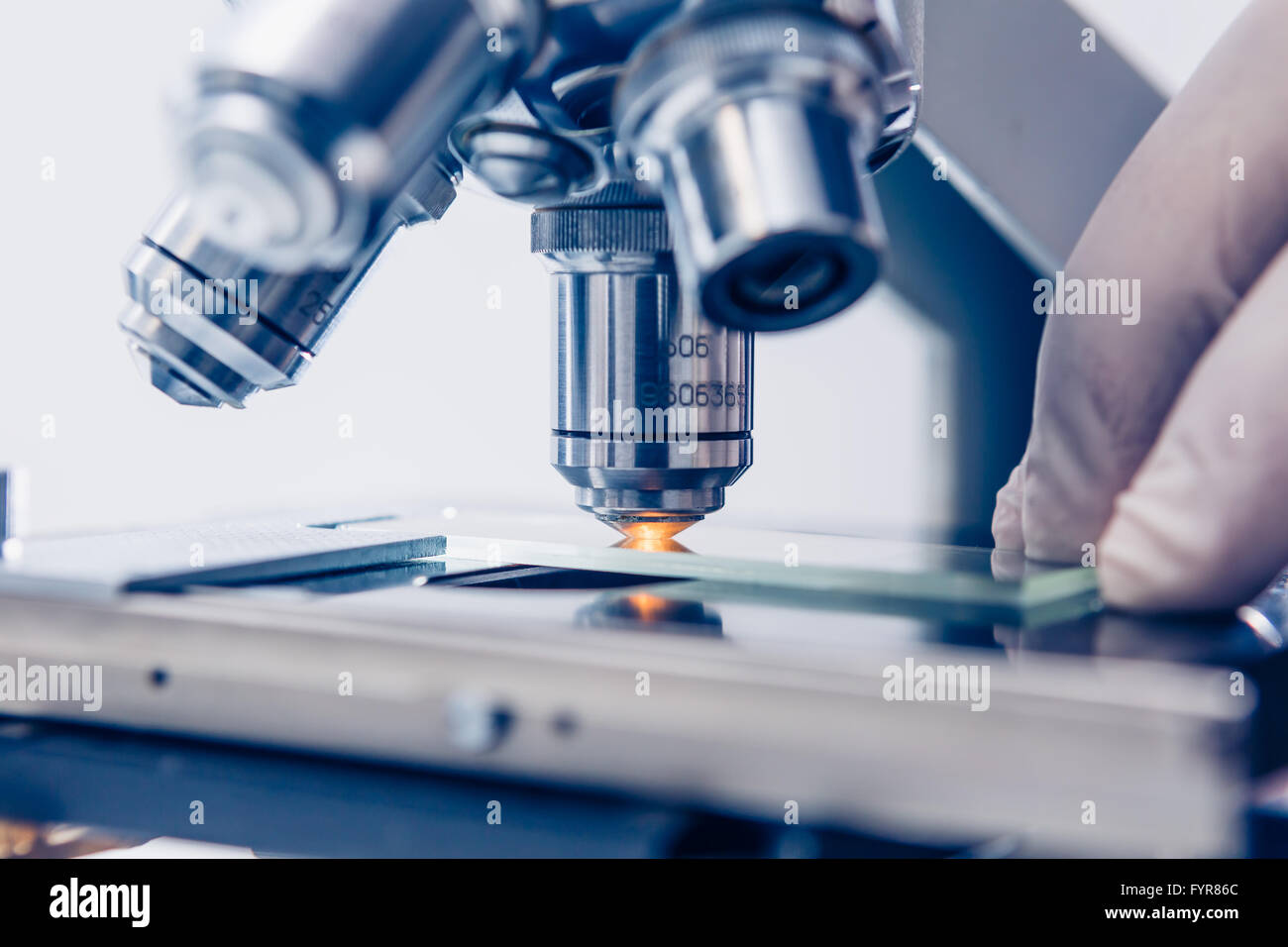 Scientist hands with microscope Stock Photo