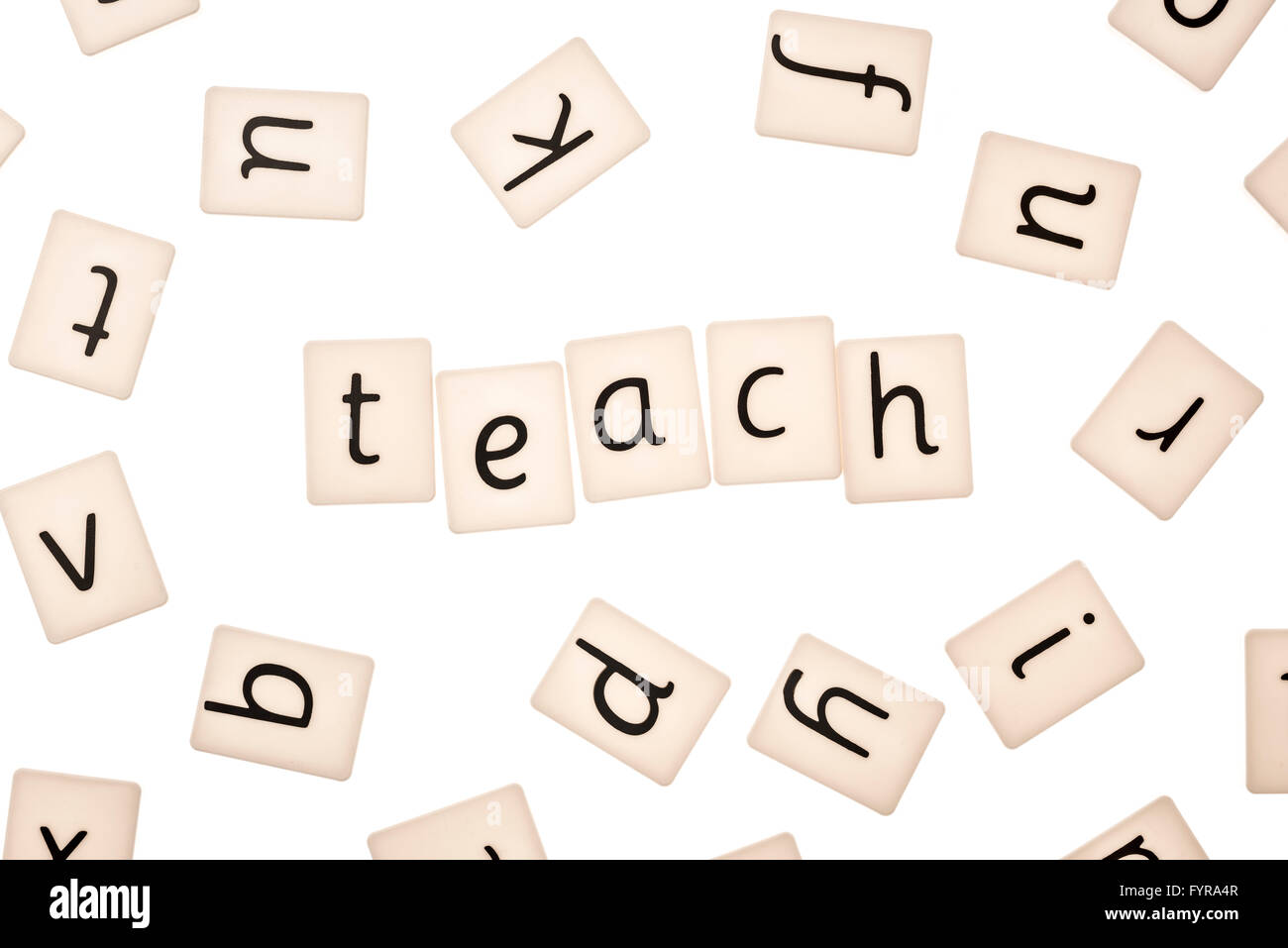 Plastic letters on white background spelling the word teach Stock Photo