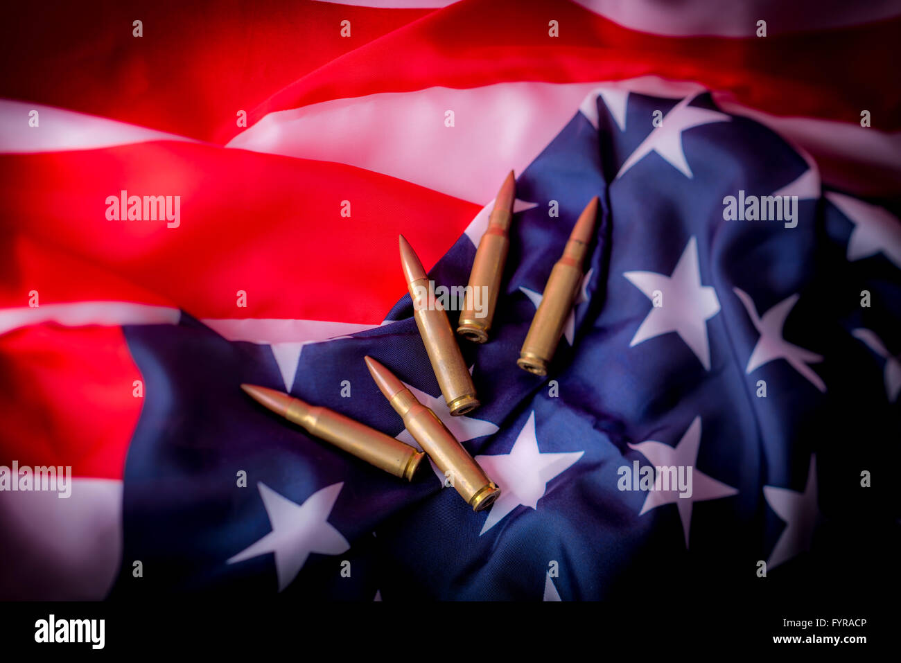 Rifle bullets and American flag Stock Photo