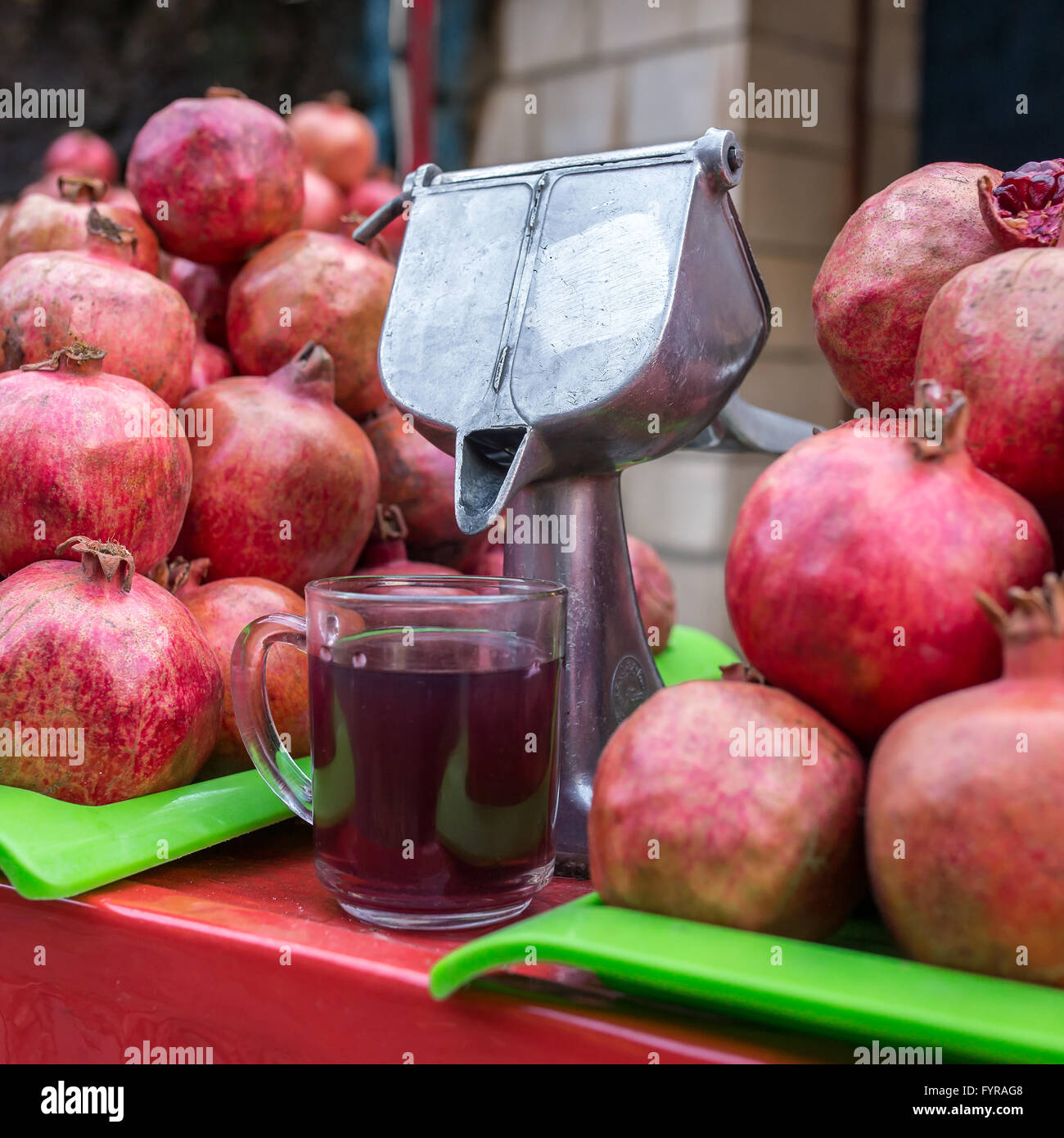 Traditional way to make delicious pomegranate juice on the streets of Tehran, Iran Stock Photo