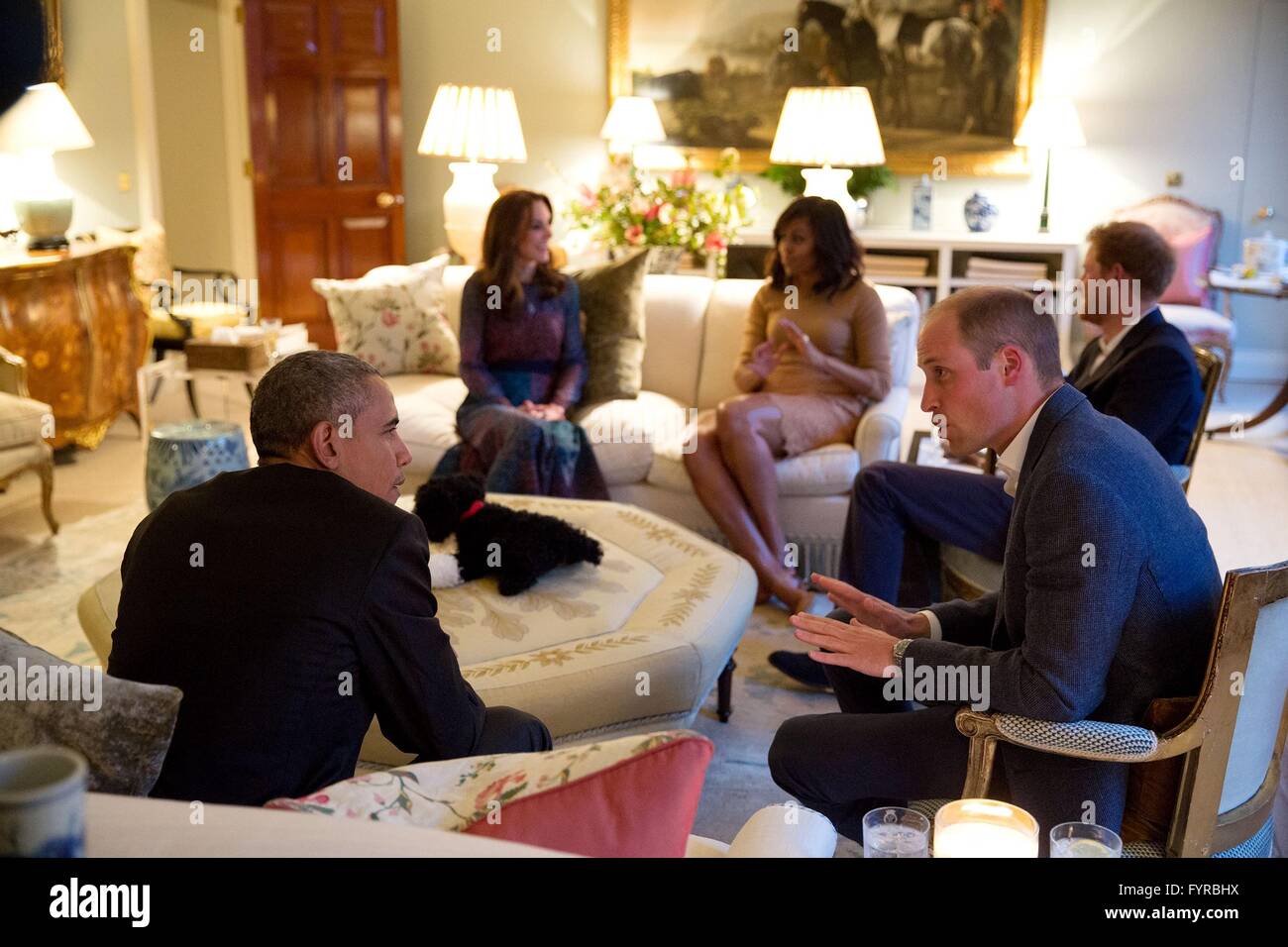 U.S President Barack Obama talks with Prince William, the Duke of Cambridge while Kate Middleton, Duchess of Cambridge and Prince Harry of Wales, speak with First Lady Michelle Obama at Kensington Palace April 22, 2016 in London, United Kingdom. Stock Photo