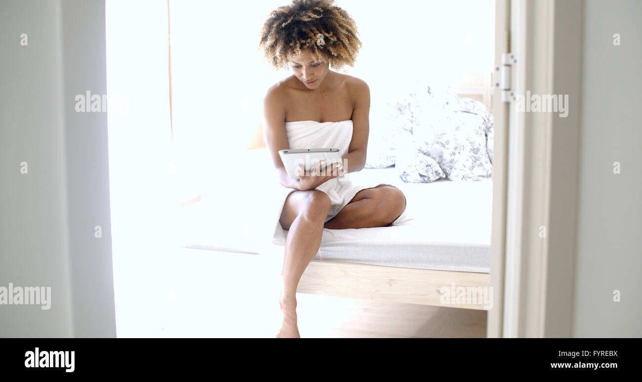 Young Woman Using Tablet On Bed Stock Photo