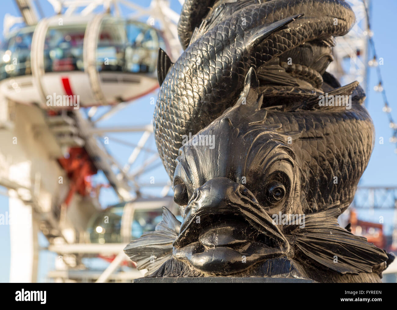 Carving of fish on riverbank by London Eye Stock Photo