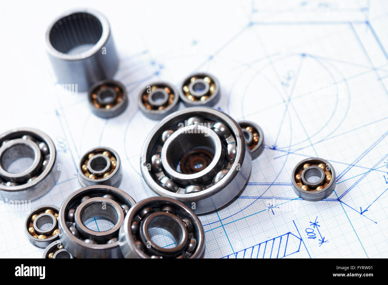 Industrial concept. Few ball bearings on graph paper background Stock