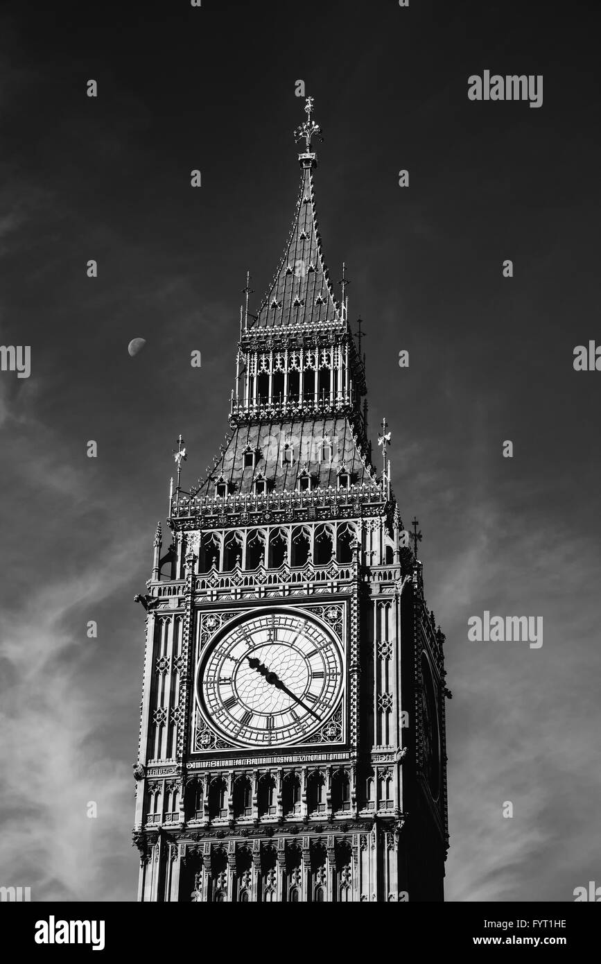 The Clock Tower in London, half Moon on its left, black and white photography, in England, UK Stock Photo