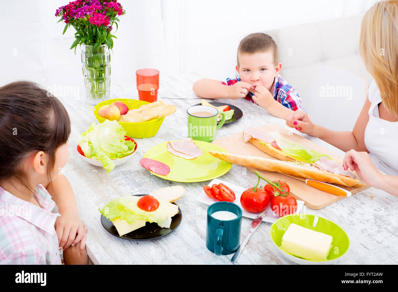 Happy family having breakfast at home Stock Photo - Alamy