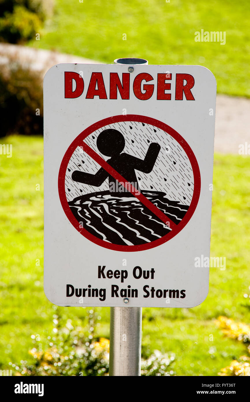 Danger, Keep out during rain storms sign Stock Photo
