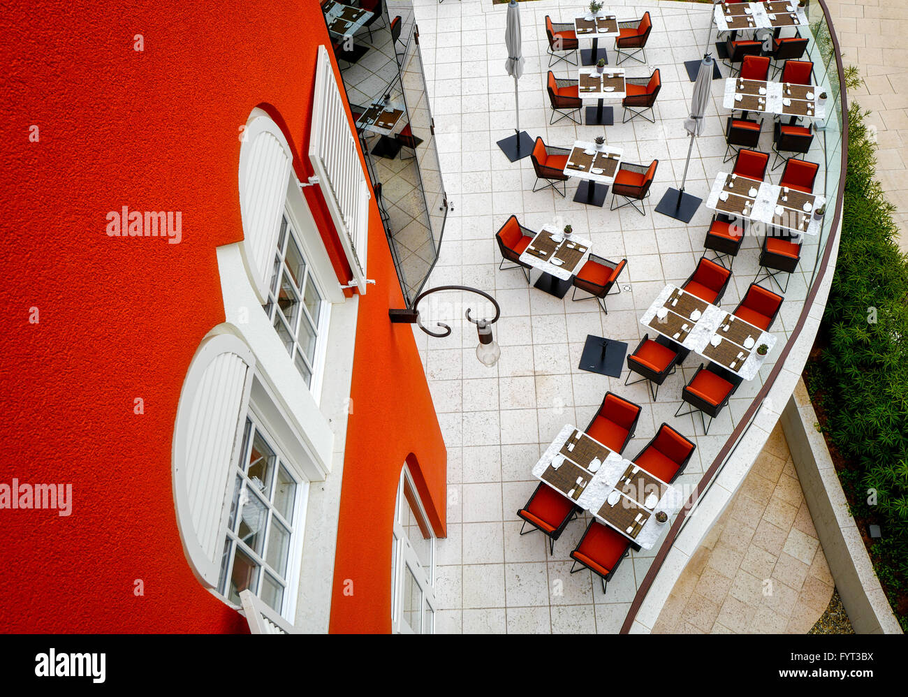 Arranged tables and chairs on restaurant terrace Stock Photo