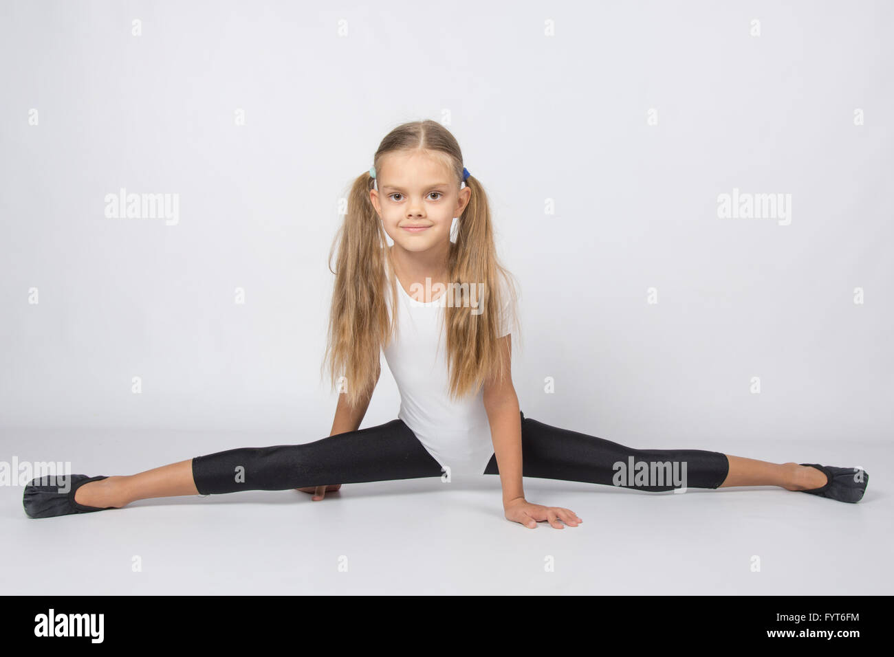 Girl gymnast almost sat down on the twine Stock Photo