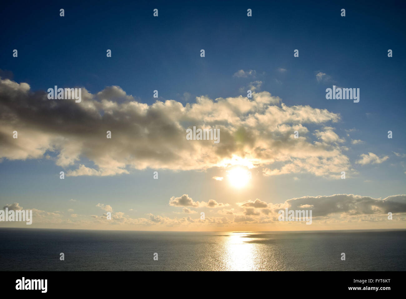 The Sun Setting in the Sea Stock Photo - Alamy