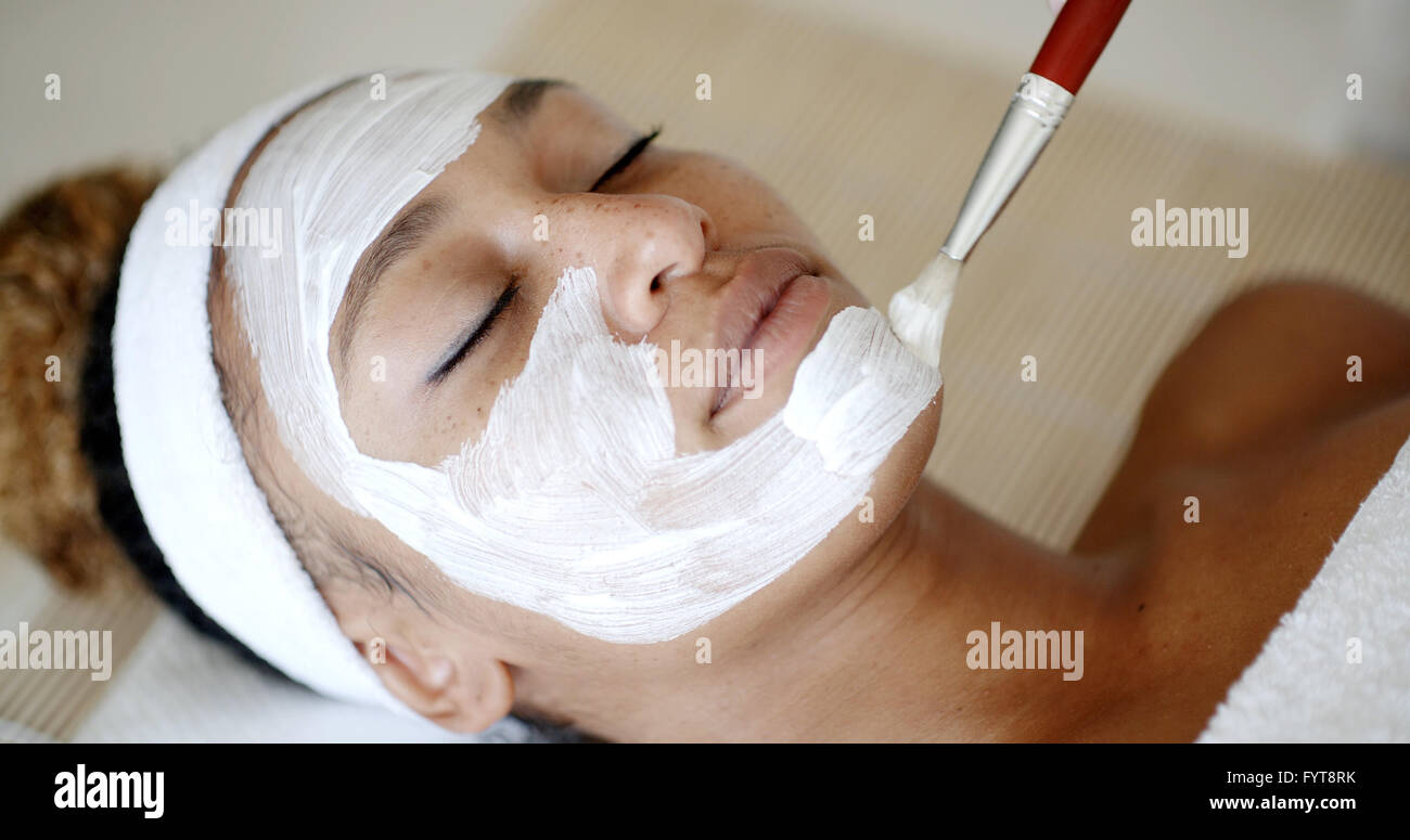 Cosmetician Applying Facial Mask Stock Photo