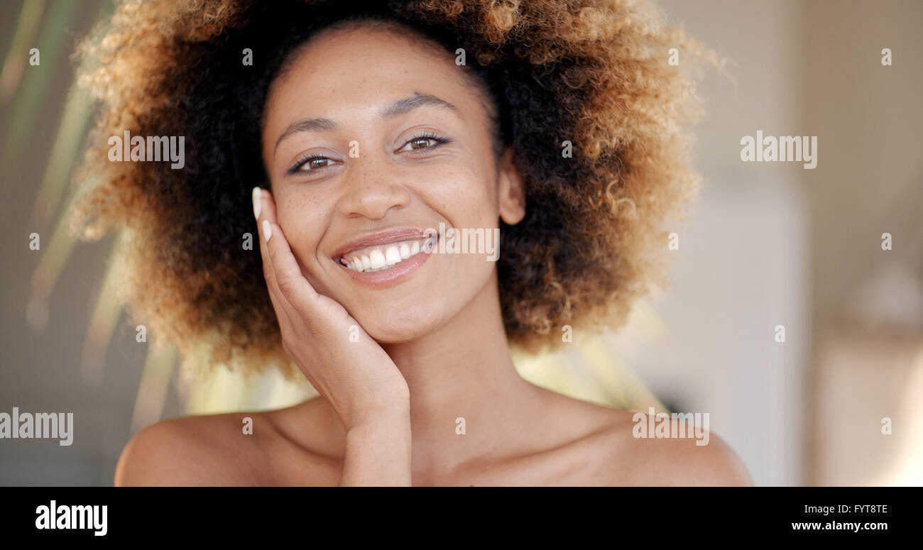 Young Woman Against Palm Tree Branch Stock Photo